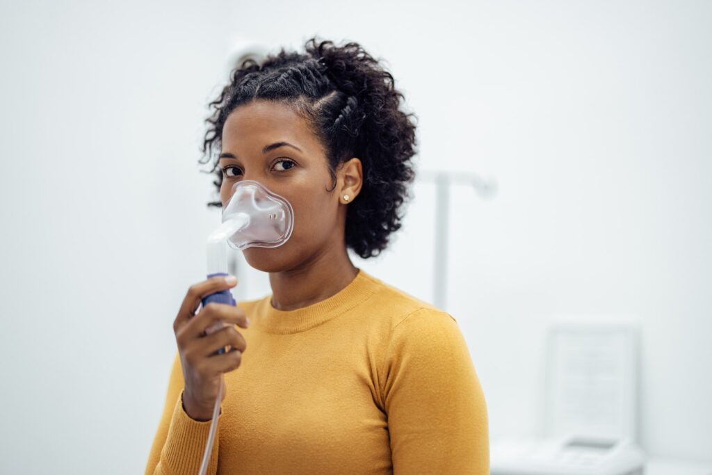 Woman with a respiratory mask at medical clinic .